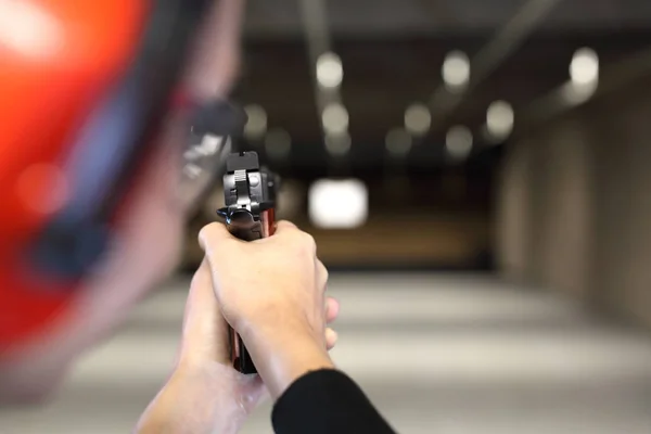 Shooting range. Shooting with a gun. Measuring to a paper target on the shooting range.