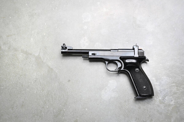 Firearm. Pistol. Gun on a gray background.