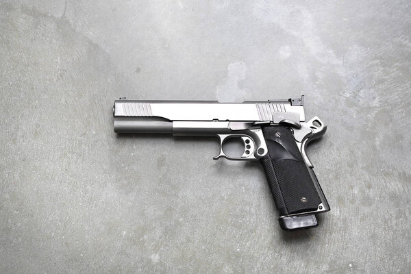 Firearm. Pistol. Gun on a gray background.