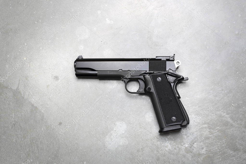 Firearm.  Gun on a gray background.