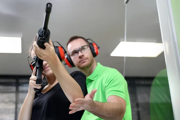 Shooting range. A woman shoots a rifle.