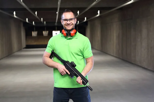 At the shooting range.Handsome man trains shooting at the sports shooting range.