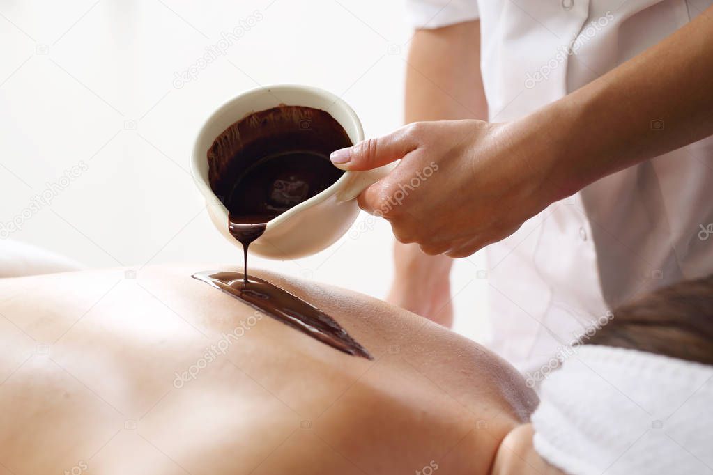 Massage with chocolate. Relax for the body in the spa salon.