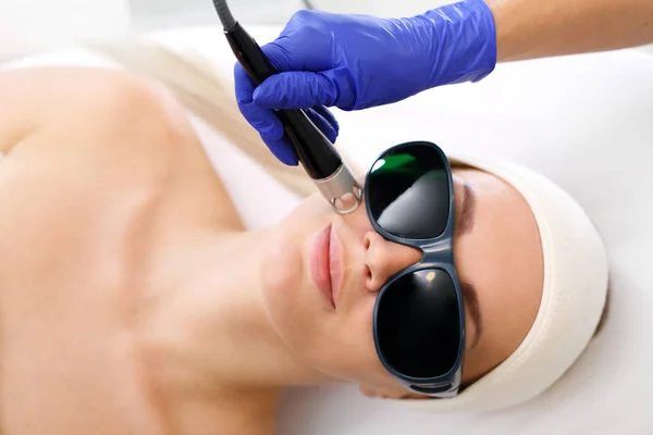 Laser treatment for the face.  A woman in a beauty salon during a laser treatment.