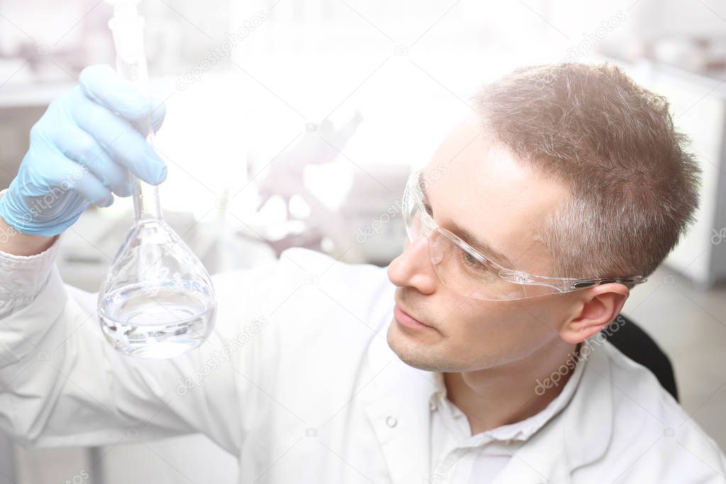 Laboratory tests and diagnostics.The lab technician is watching the specimen in the test tube.