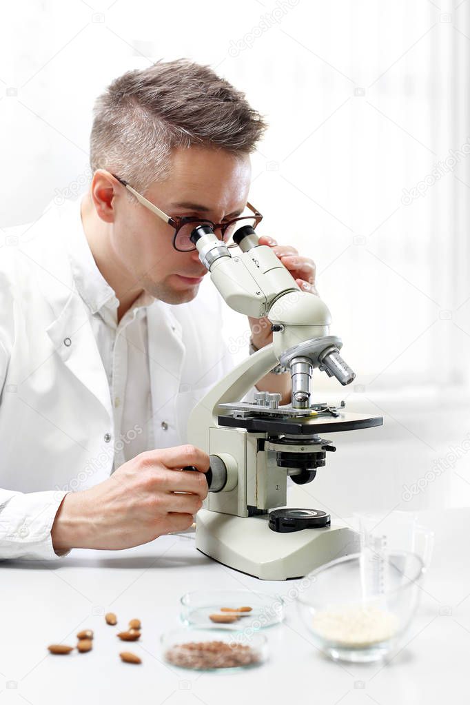 Microbiology, examination under a microscope. The lab technician analyzes the microscope in the laboratory lab.