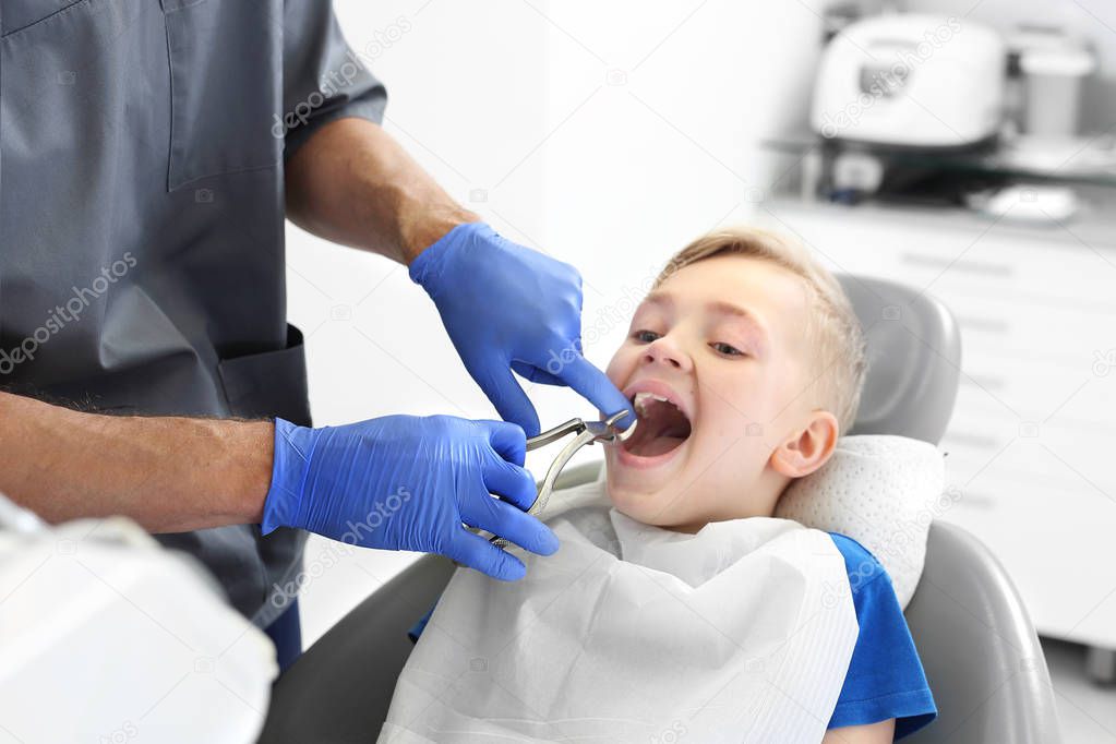 Extraction, tooth extraction, dental office. Child at the dentist