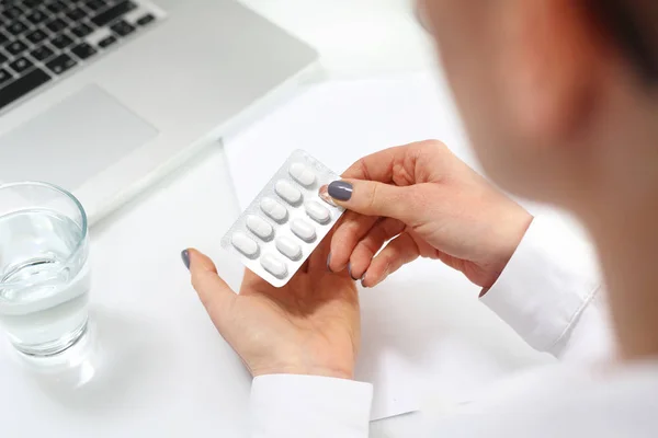 Una mujer en el trabajo está tomando analgésicos . — Foto de Stock