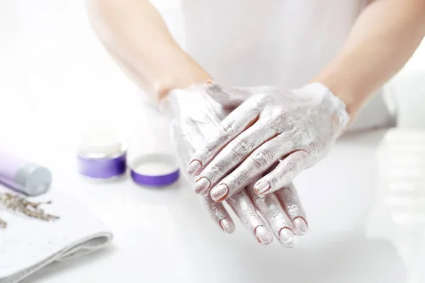 Hand spa. The woman puts a mask on the skin of the hand. Hand skin care. — Stock Photo, Image