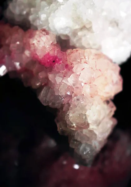 Gemstone closeup as a part of cluster filled with rock crystals.