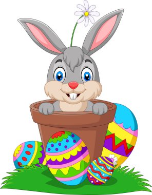 Vektör çizim karikatür bunny Paskalya ile tencerede çimenlerin üzerinde yumurta