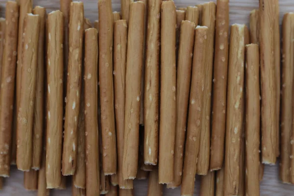 Salty and crunchy stick crackers on wooden desk