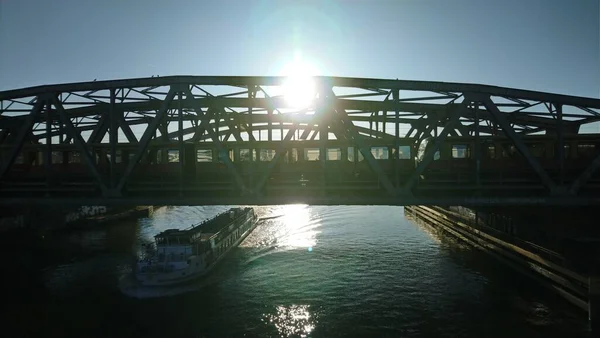 Train on the bridge and a ship under the bridge in Berlin city