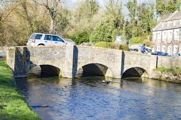 The car crossing the bridge in bibury village of cotswolds