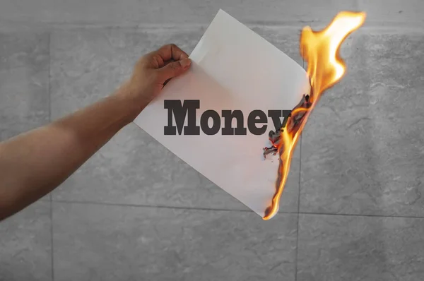 Money text on fire with burning paper