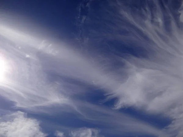 Beautiful strange clouds on blue sky background texture