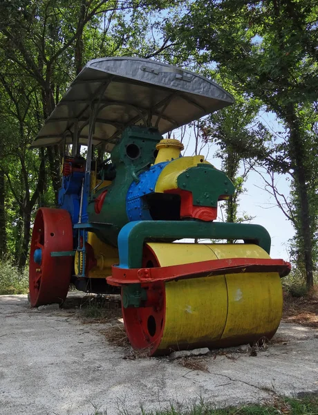 Vintage steam roller, painted in bright colors, used as tourist attraction