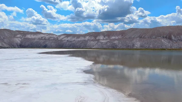 Salt production. Salt piles among the green fields. Salt lake mining of potassium salts. The road to the salt cave. Drone footage of the quarry.