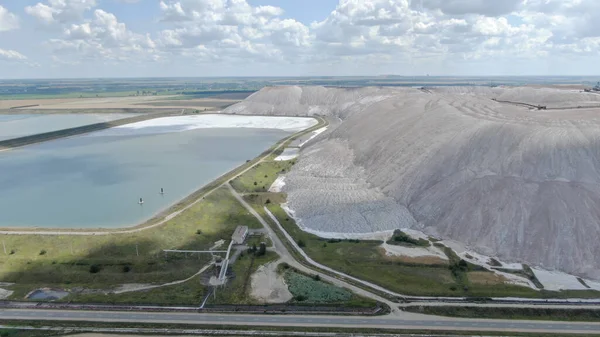 Salt production. Salt piles among the green fields. Salt lake mining of potassium salts. The road to the salt cave. Drone footage of the quarry.