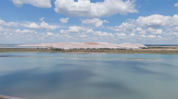 Salt production. Salt piles among the green fields. Salt lake mining of potassium salts. The road to the salt cave. Drone footage of the quarry.