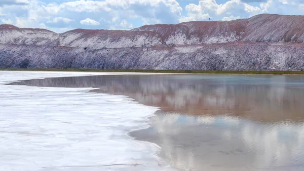 Salt production. Salt piles among the green fields. Salt lake mining of potassium salts. The road to the salt cave. Drone footage of the quarry.