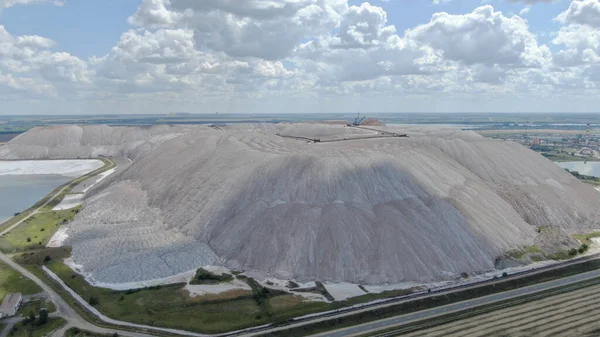 Salt production. Salt piles among the green fields. Salt lake mining of potassium salts. The road to the salt cave. Drone footage of the quarry.