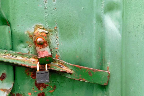 rusty green metal texture of cargo container with padlock