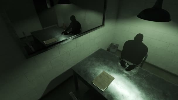 depositphotos_198080088-stock-video-silhouette-man-sitting-dark-interrogation.jpg