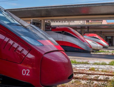 Venice, Italy - 08 May 2018: Railway station of Venice. The nose of the locomotives standing in a row. Trenitalia is the main railway operator in Italy. In the foreground is the locomotive of Italo clipart