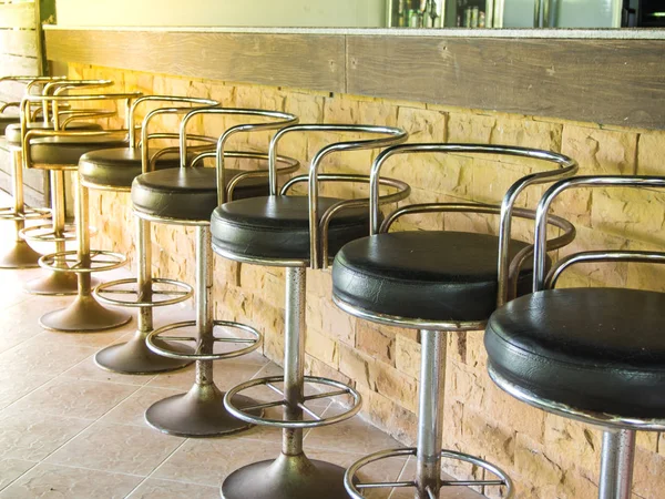 row of stool chairs in front of the counter in the restaurant
