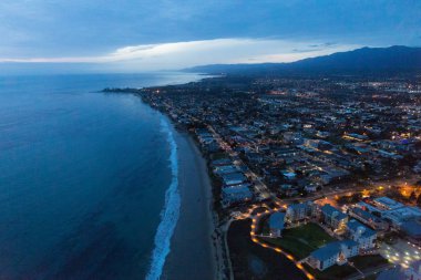 Aerial helicopter shot of Santa Barbara at night clipart