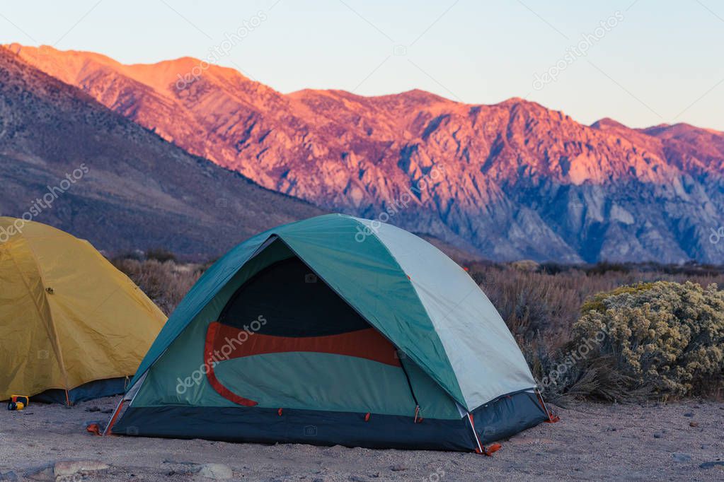 Sunrise on a tent pitched in the high desert of Bishop, California surrounded by the mountains of the Sierra Nevada