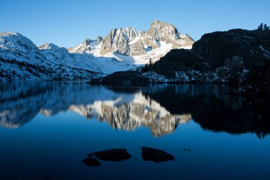 Sunrise on Banner Peak above Garnet Lake in the Ansel Adams wilderness after a fresh snow clipart