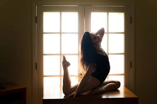 Middle Aged Caucasian Woman Black Leotard Poses Table While Backlit — Stock Photo, Image