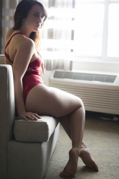 Young Caucasian Woman Sits Chair Natural Light While Wearing Red — Stock Photo, Image