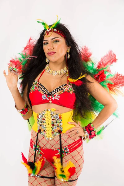 Very fit young hispanic woman in Carnaval costume and athletic shoes posing on clean white background