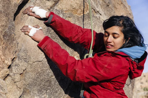 South Asian woman rock climbs in the desert
