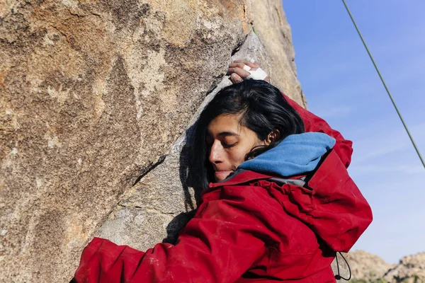 South Asian woman rock climbs in the desert