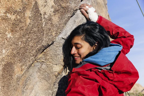 South Asian woman rock climbs in the desert