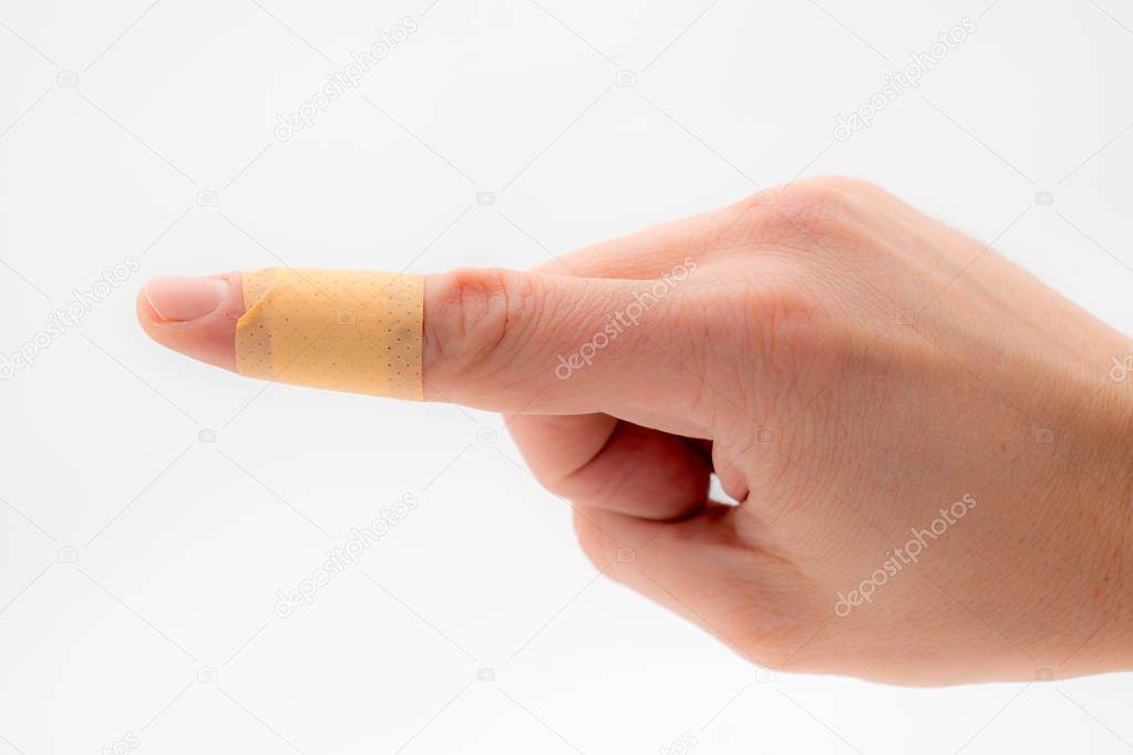 a hand with a patch on the forefinger, isolated against a white background.