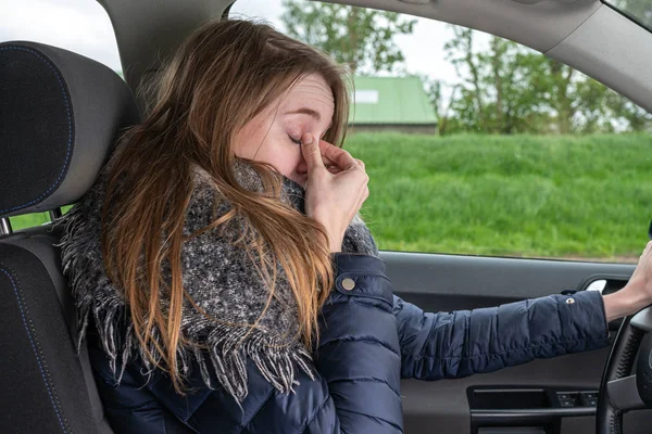 Woman driving overtired car and rubbing her eyes — 스톡 사진