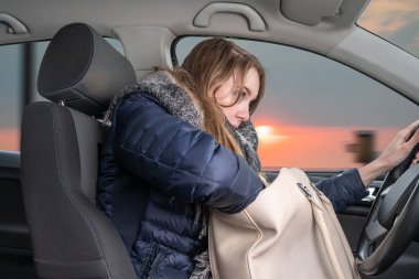 Young woman is distracted while driving car clipart
