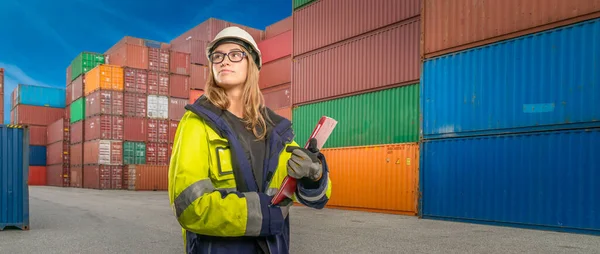 a Young female port worker in the background containers
