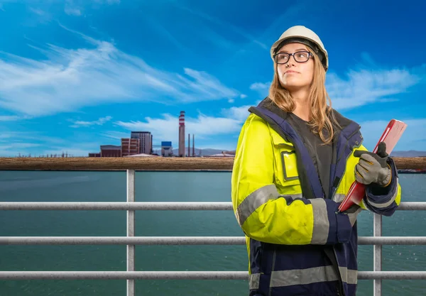 a female engineer on a ship in safety clothing