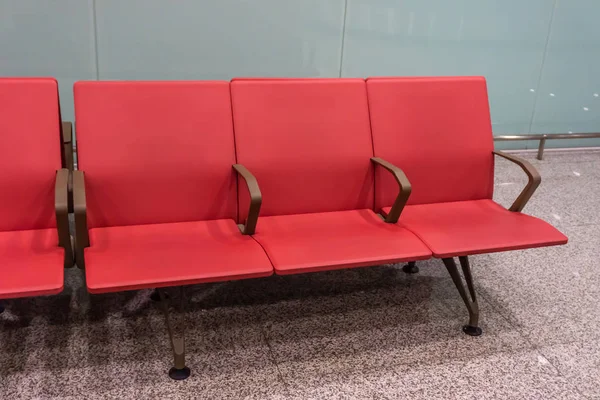 Red Colored Airport Seating Row at Baggage Claim Hall