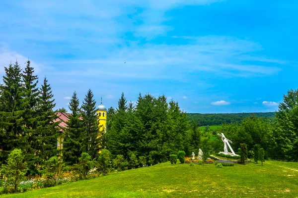 Bursuc Hancu Monastery Landscape View of the Garden and Forest with a Monument of God Jesus Christ Bearing the Cross on His Back