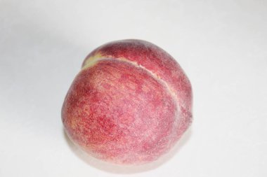 Beyaz arka plan üzerinde masanın üzerinde yatan şeftali