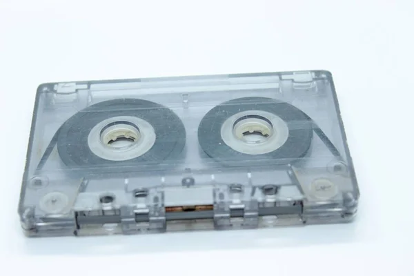 The audio cassette is located on a white background — Stock Photo, Image