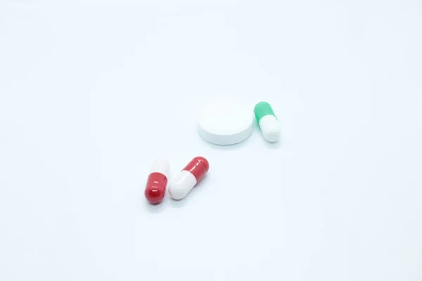 Multi-colored pill capsules are located on a white background — Stock Photo, Image