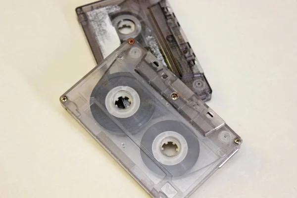 Two audio cassettes located on a white background